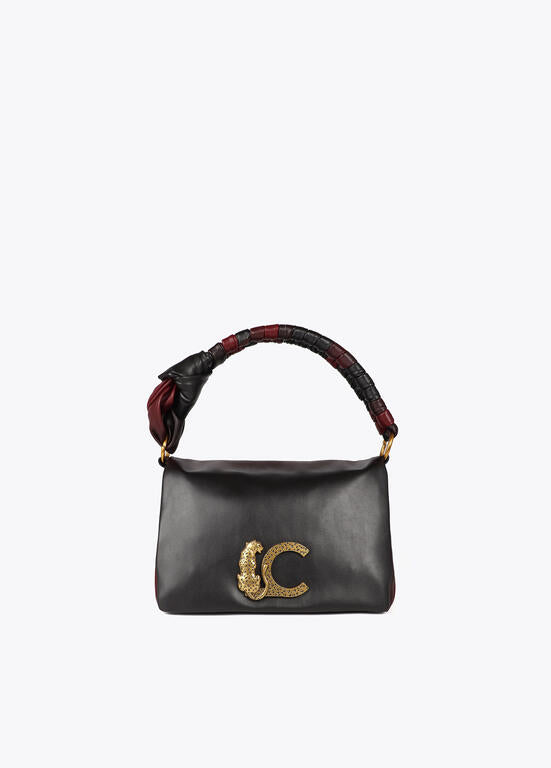 Bandolera Lola Casademunt  con solapa y nudo en asa. Logo LC leopardo negro-rojo
